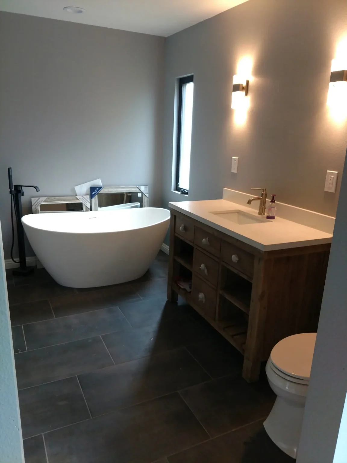 bathroom remodeling contractor walk-in glass shower tile floor installation custom vanity lighting upgrade